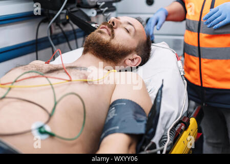 Paramedic attending to patient in ambulance . Stock Photo