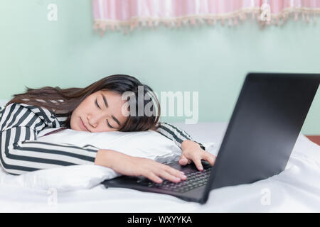 pretty woman sleep after play social network on the bed in vacation day Stock Photo
