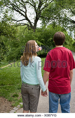 Teenage girl blowing a bubble gum bubble