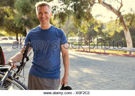 Portrait of mature male cyclist in park