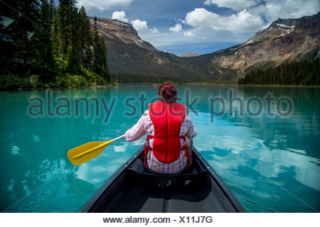 Woman canoeing in Emerald Lake, Yoho National Park, British Columbia Canada