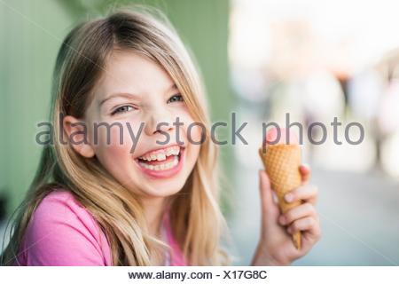 Portrait of young girl eating icecream