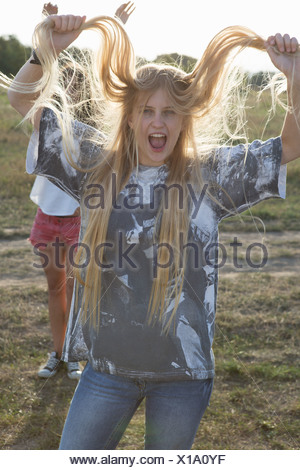 young woman holding long blonde hair x1a0yf - Finest Foreign Women of all ages to Marry