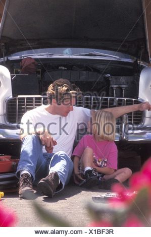 Father And Daughter Fixing Car Engine In Driveway Stock Photo: 71140063 