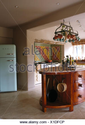 Pans On Rack Above Island Unit With Storage Baskets On Shelves In
