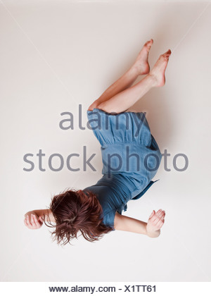 upside down view of young happy woman reading emails on a smart phone ...