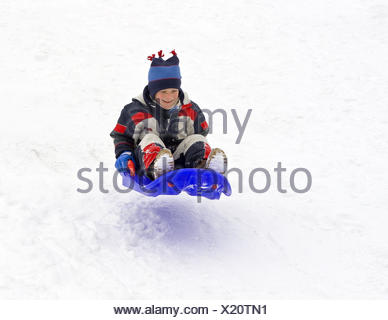 A Boy 6 Years In The Snow Suit With The Sledge Bob Drag Go