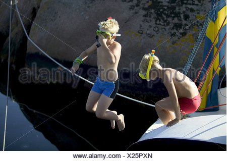 Download Children in scuba masks swimming in swimming pool Stock ...