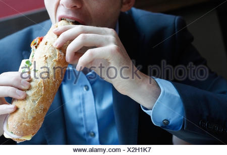 Man biting into a sandwich Stock Photo: 62964614 - Alamy