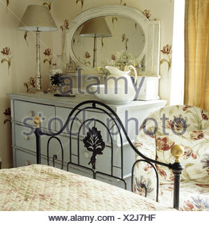 Ornate Black Wrought Iron Bed In Cottage Bedroom With Tulip Patterned ...