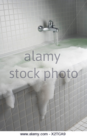 An overflowing bubble bath Stock Photo - Alamy