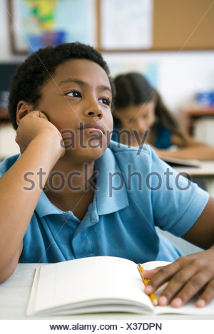 African-American male student sits alone at table during 