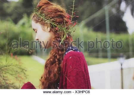 Side View Of Young Woman Wearing Flowers In Hair