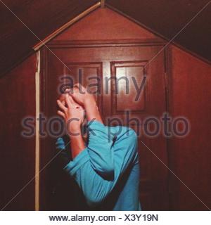 Man Covering Face With Hands Outside House
