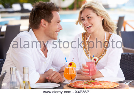 https://l450v.alamy.com/450v/x4p36p/couple-enjoying-meal-in-outdoor-restaurant-x4p36p.jpg