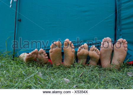 Four People S Feet Sticking Out Of Tent Door Stock Photo 15194137 Alamy