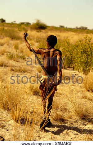 Bushman Walking Through Kalahari Desert, Botswana, Africa Stock Photo ...