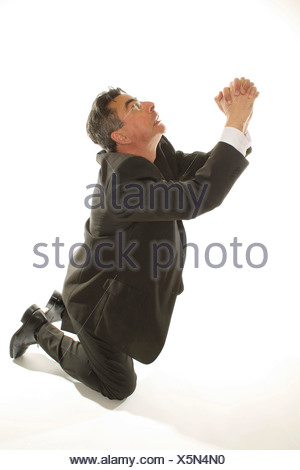 Kneeling Businessman Praying For Mercy Stock Photo: 17172685 - Alamy