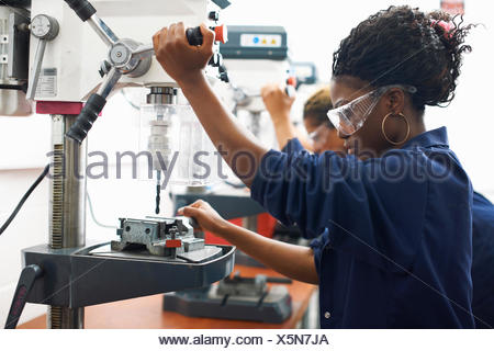 Students using drilling machines in college workshop