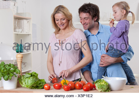 munich bavaria germany cooking man grinder pepper woman daughter alamy preparing salad father standing mother background