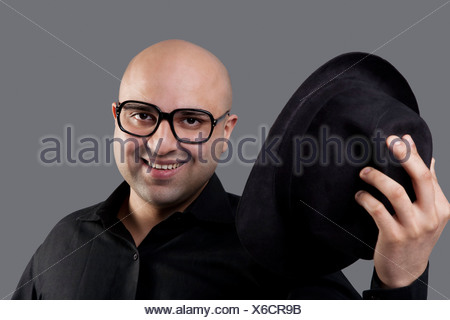 Bald man taking off his hat