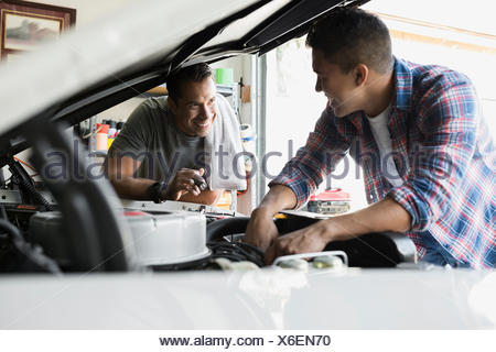 Father And Son Restoring Vintage Car Engine Garage Stock Photo