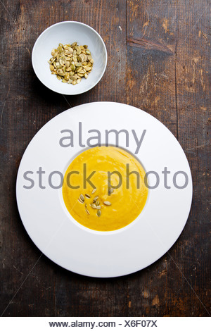 Pumpkin soup with pumpkin Seeds on wooden background