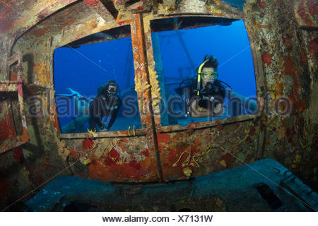 Divers peer through windows on bridge of USS Kittiwake