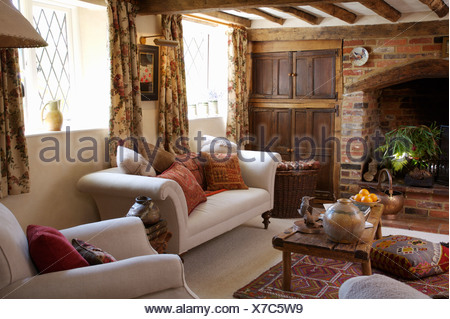 Rustic country sitting room brick fireplace open fire sofa coffee table ...