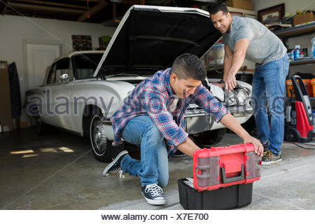 Father And Son Restoring Vintage Car Engine Garage Stock Photo