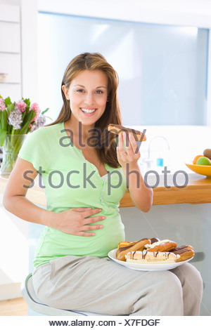 Young Pregnant Women Eating a Plate of Fruit Stock Photo ...