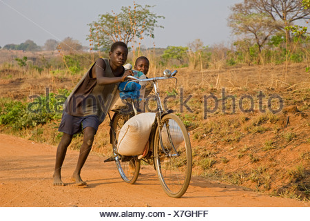 Young local kids boy walking half naked and bare foot in 