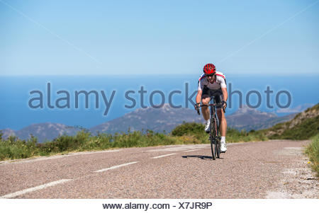 Man cycling on road, Corsica, France