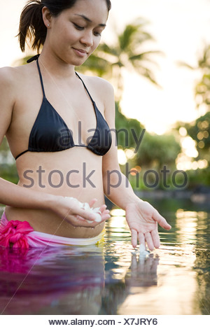 https://l450v.alamy.com/450v/x7jry6/woman-in-water-with-flowers-x7jry6.jpg