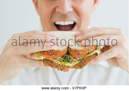 Man biting into a sandwich Stock Photo: 62964614 - Alamy