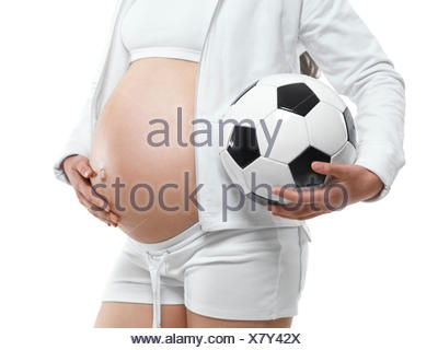 Studio shot of young female soccer player kicking ball mid air Stock ...