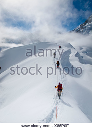 Rope team mountaineering on the narrow ridge of Control Tower above ...