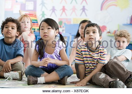 Group of nursery children sitting on the floor in their classroom Stock ...