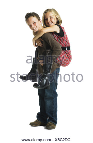 Boy giving girl piggy back ride smiling