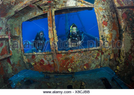 Divers peer through windows on bridge of USS Kittiwake
