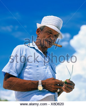 Older Cuban men smoking cigars in the PLAZA MAYOR - TRINIDAD, CUBA ...