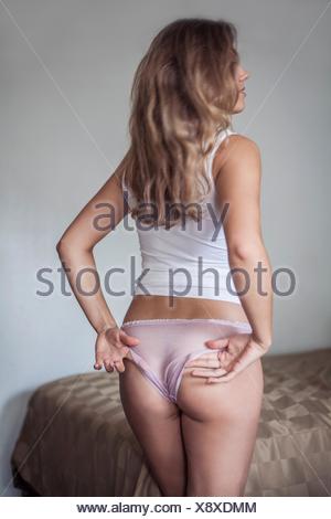 Download Backview of woman adjusting knickers Stock Photo - Alamy