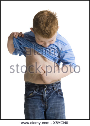 boy looking at his belly button Stock Photo - Alamy