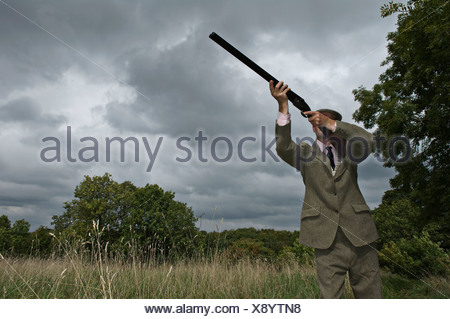 man shooting hot brass at range