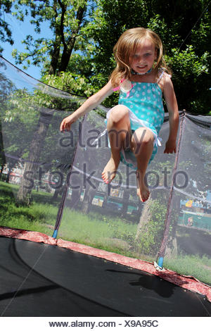 girl jumps on the trampoline Stock Photo - Alamy