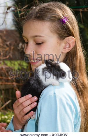 Girl, 10 years old, with pet rabbit Stock Photo - Alamy