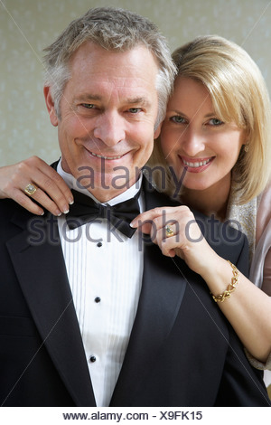 https://l450v.alamy.com/450v/x9fk15/middle-aged-woman-tying-husbands-bow-tie-portrait-x9fk15.jpg