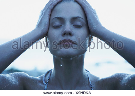 Young Woman in rain wearing bikini