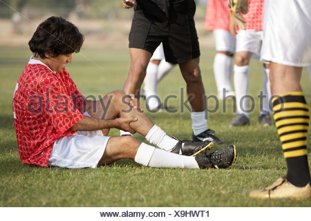 Full Length Portrait Of An Injured Soccer Football Player On Crutches ...