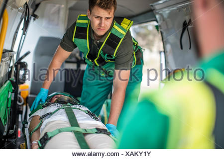 Paramedics moving car crash victim on stretcher Stock Photo: 132071471 ...